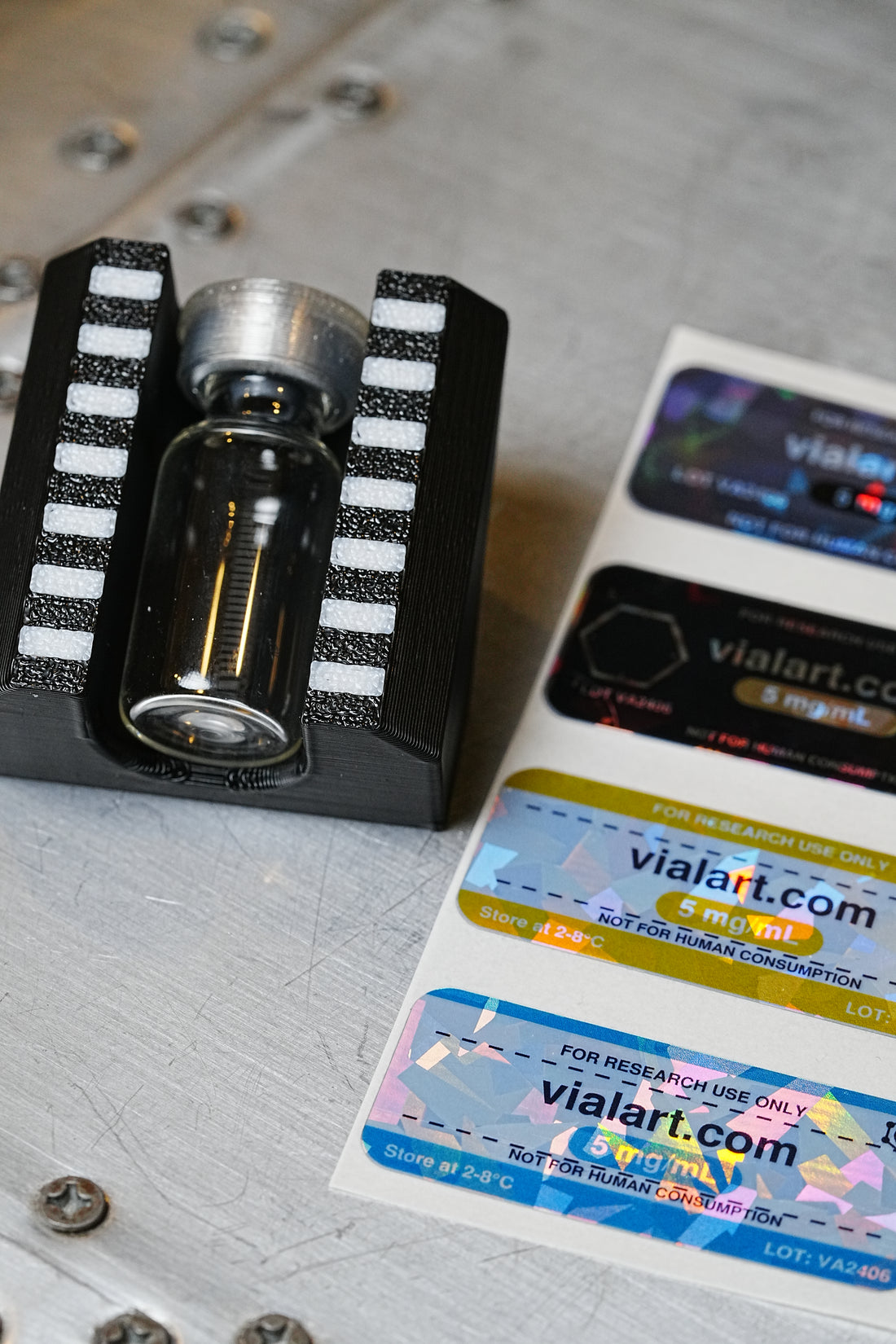 3 mL vial labeling stand holding a glass vial next to printed vial labels