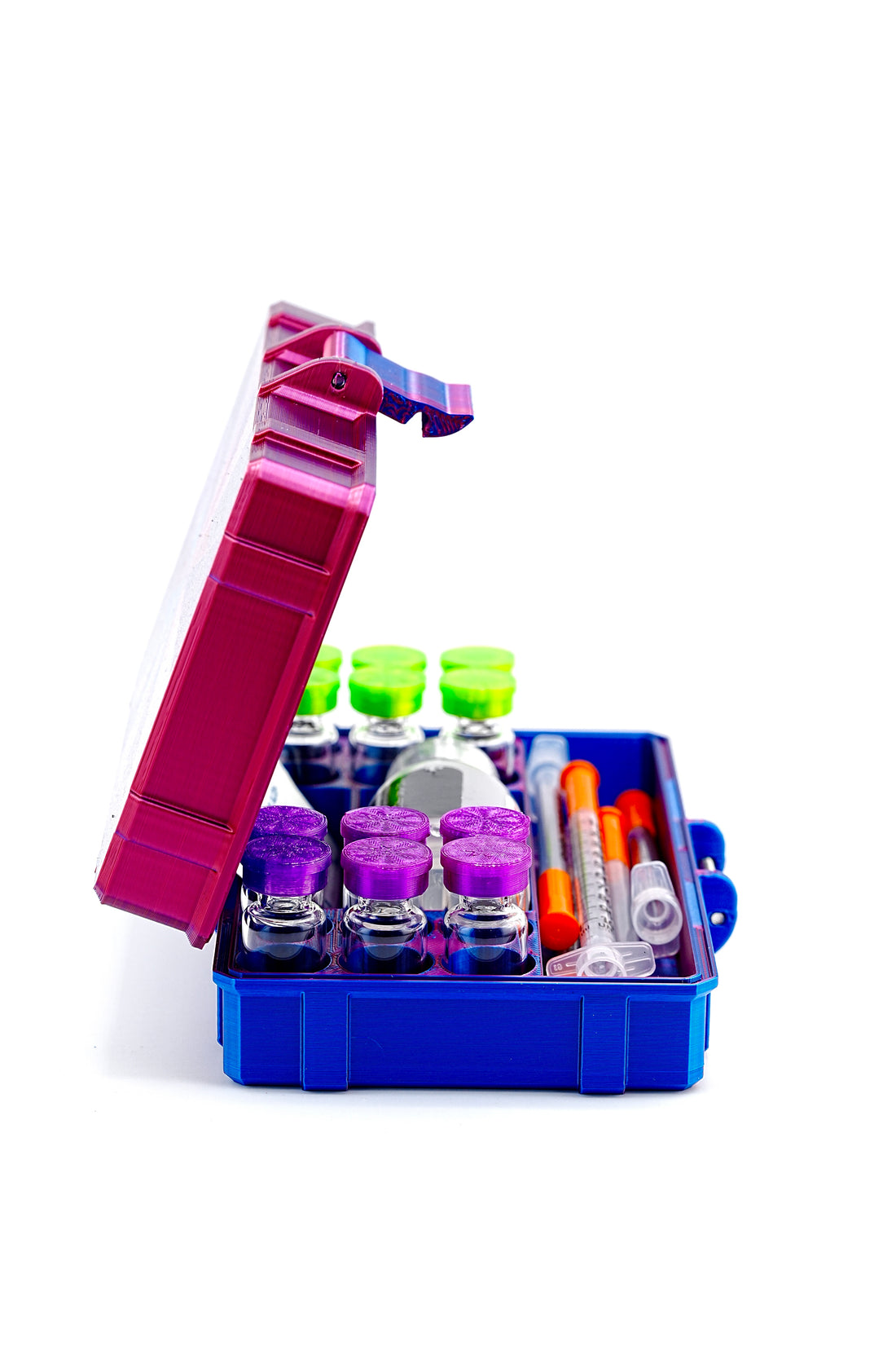 Open blue sample storage box with various colored bottles and containers on a white background