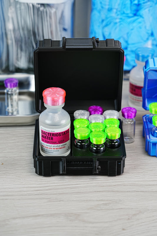 BPC-157 storage supplies — black hard-shell VialCase containing a 30 mL bacteriostatic water bottle and six peptide vials with green and silver caps