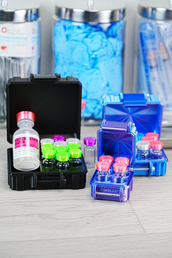 Complete peptide reconstitution supplies kit — VialCase organizer with peptide vials, Hospira bacteriostatic water bottle, blue nitrile gloves, and an alcohol-pad jar
