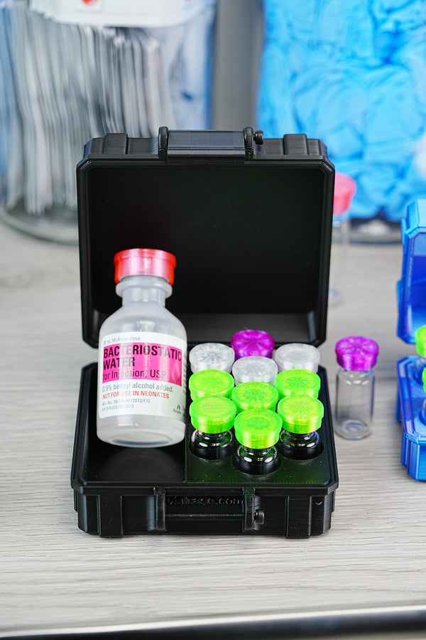 Best TRT injection supplies kit — black VialCase storage with Hospira bacteriostatic water bottle and organized testosterone vials with colored stopper caps
