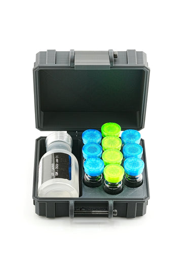 Open black case with a bottle and colorful vials on a white background