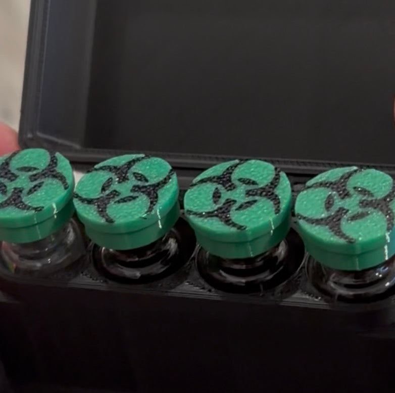 Bio Green flexible vial caps with a black biohazard symbol on capped vials