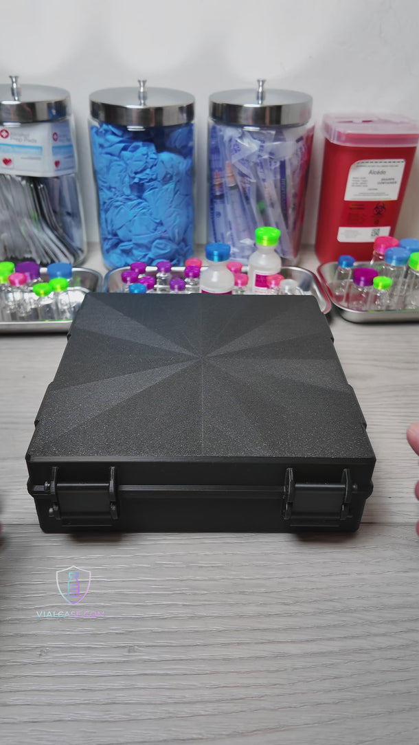 Large hard-shell case opened to show rows of vials stored in individual slots, demonstrating high-capacity organized storage in a professional setting.