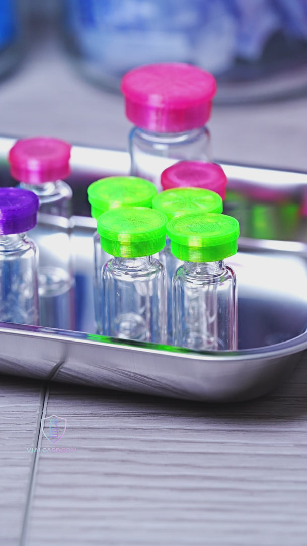 Close-up of flexible vial caps being placed onto vial tops, showing secure fit and protective coverage for travel and storage.