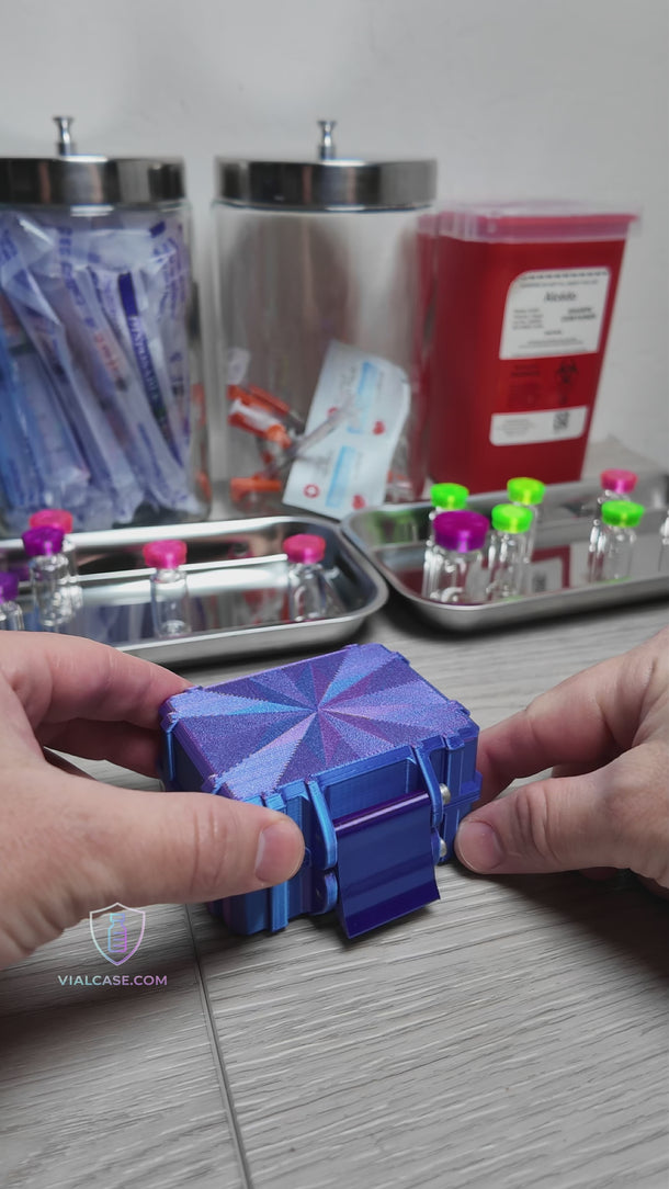 Compact peptide storage case opened to reveal ten 3ml vials arranged neatly in individual slots. A hand places or removes vials to demonstrate fit and organization. The case sits on a clean workspace with medical supplies visible in the background.
