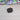 Black rectangular object with a stand on a white background

